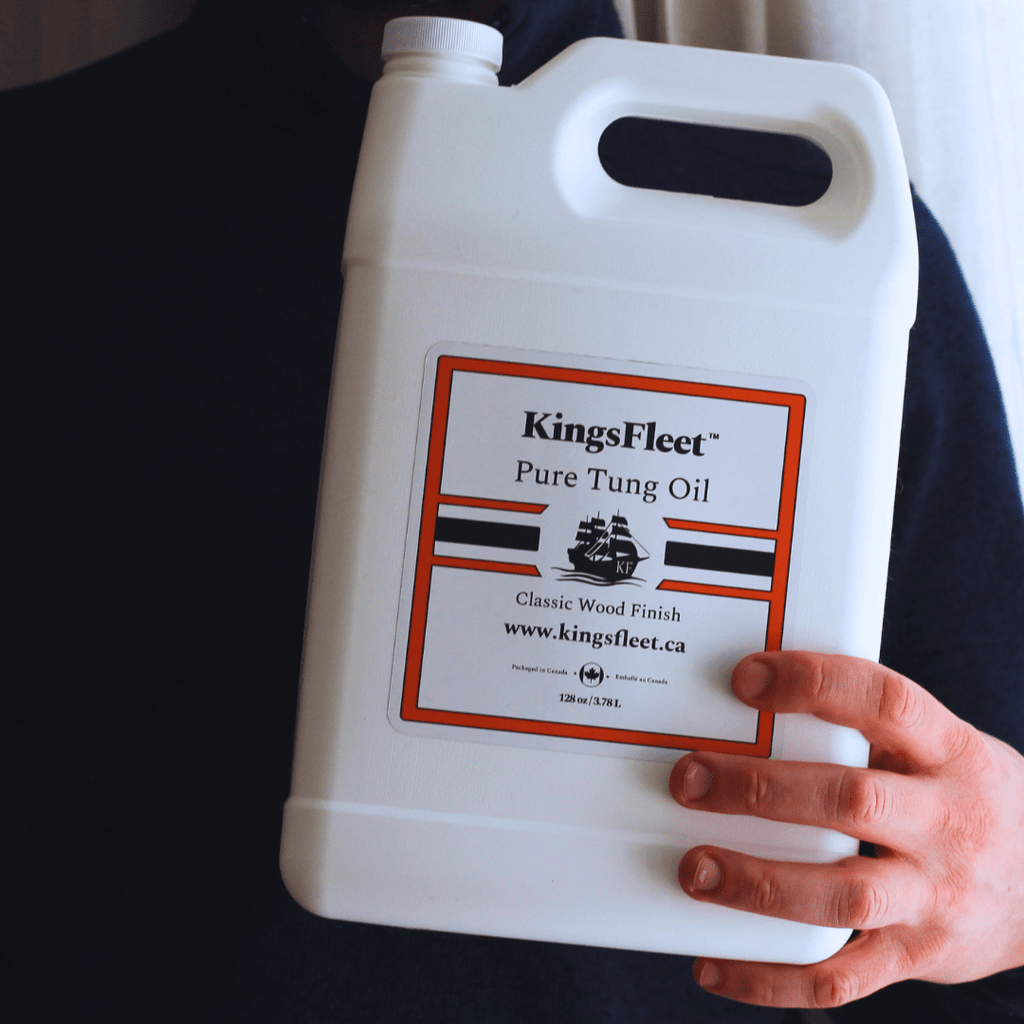 KingsFleet Pure Tung Oil, 128oz, in hand. With labels highlighting. No additives, Zero VoCs, Pure Tung Oil.